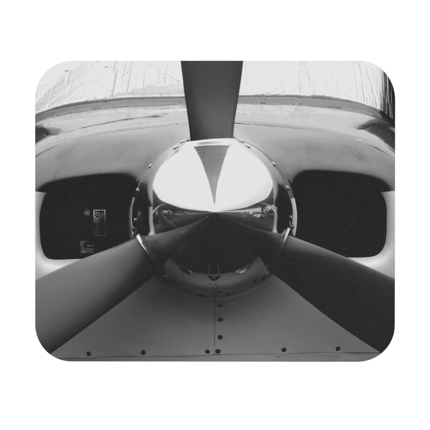 A mouse pad with a black and white photograph of a propeller in the center.
