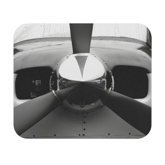 A mouse pad with a black and white photograph of a propeller in the center.