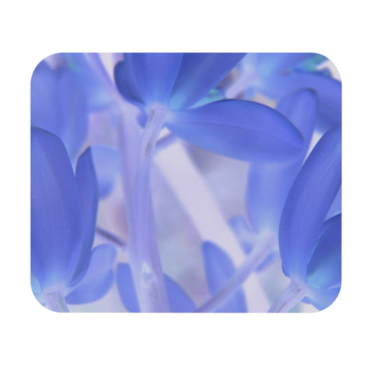 A close-up image of a mouse pad with a vibrant design of blue tinted orchids.