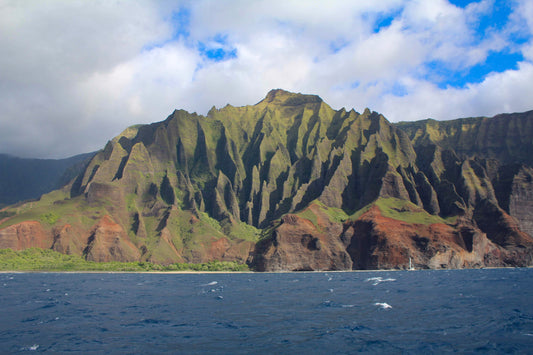 A photograph of the Napali Coast on Kauai, Hawaii, featuring rugged cliffs and lush greenery. Napali Coast, Kauai Hawaii, Original Photograph by Kim A. Bailey