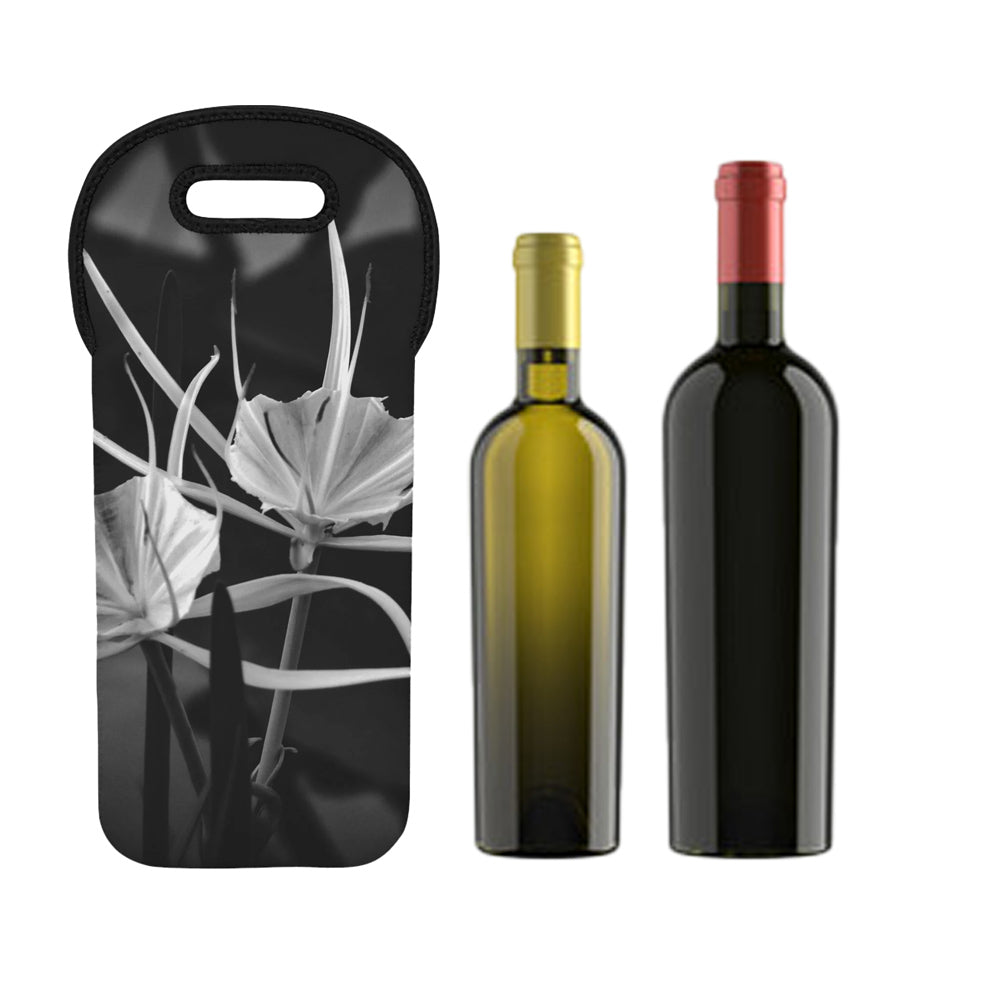 Two wine bottles and a black bag with floral design on a white background