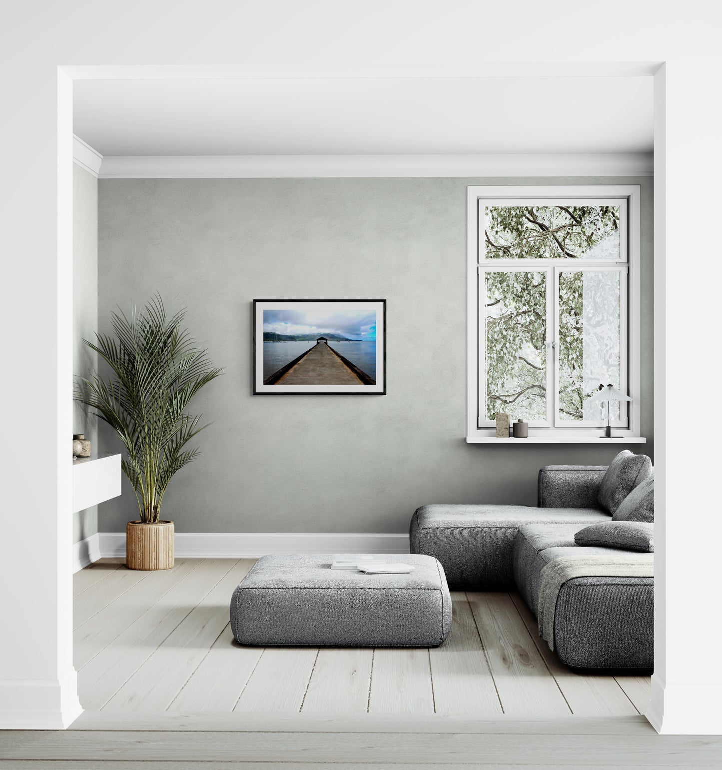 Modern living room with gray sofa, ottoman, and wall art.