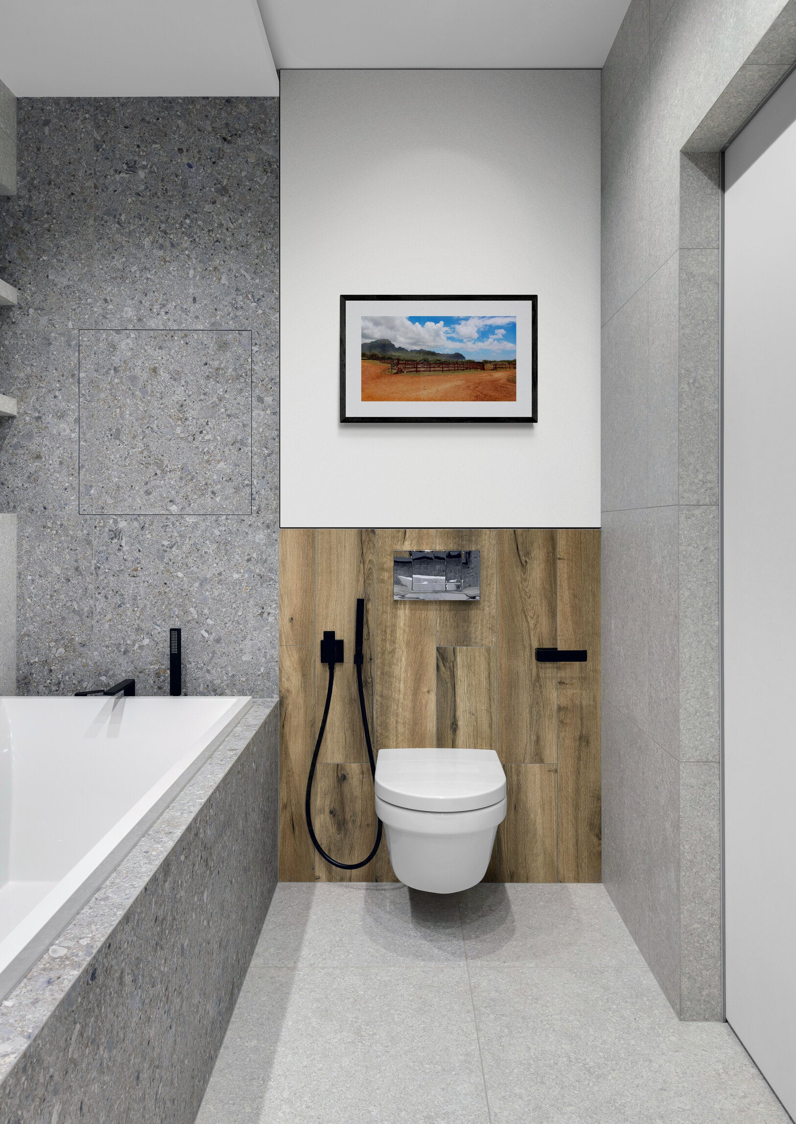 Modern bathroom with toilet, sink, and wall art.