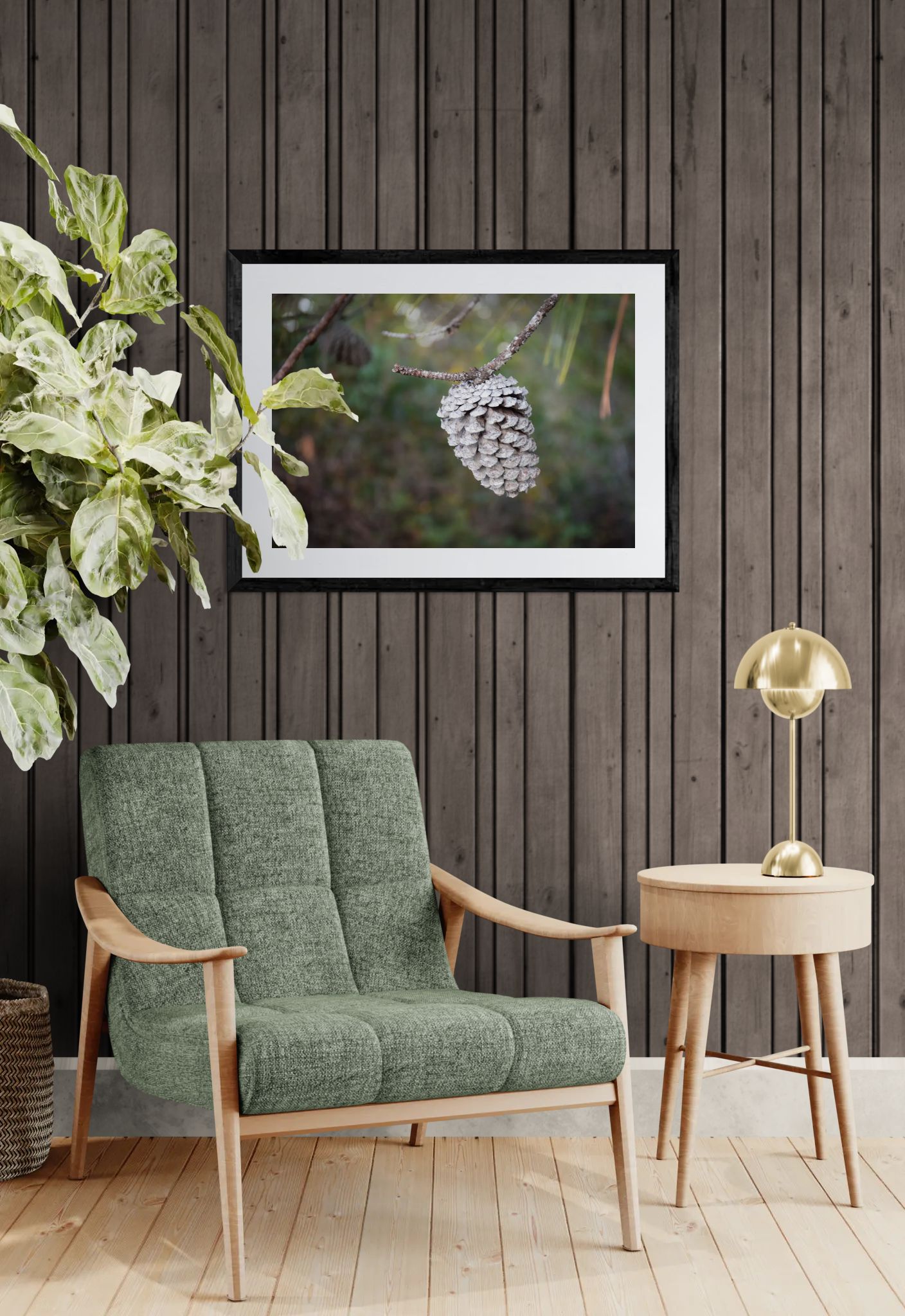Single Pinecone hanging over a green sofa in a room with a framed picture on the wall and a small table with a lamp.