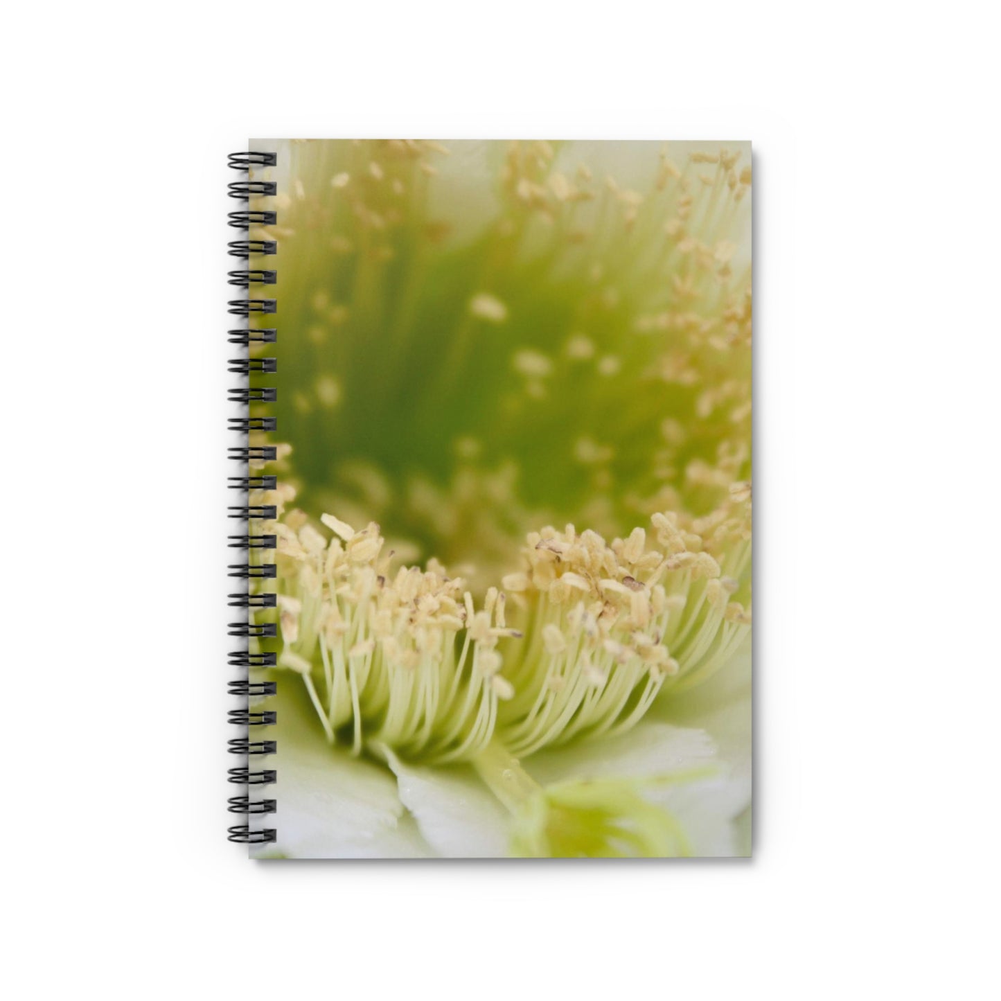 A spiral notebook with a floral photograph cover, featuring a close-up image of a plant with green and white colors.
