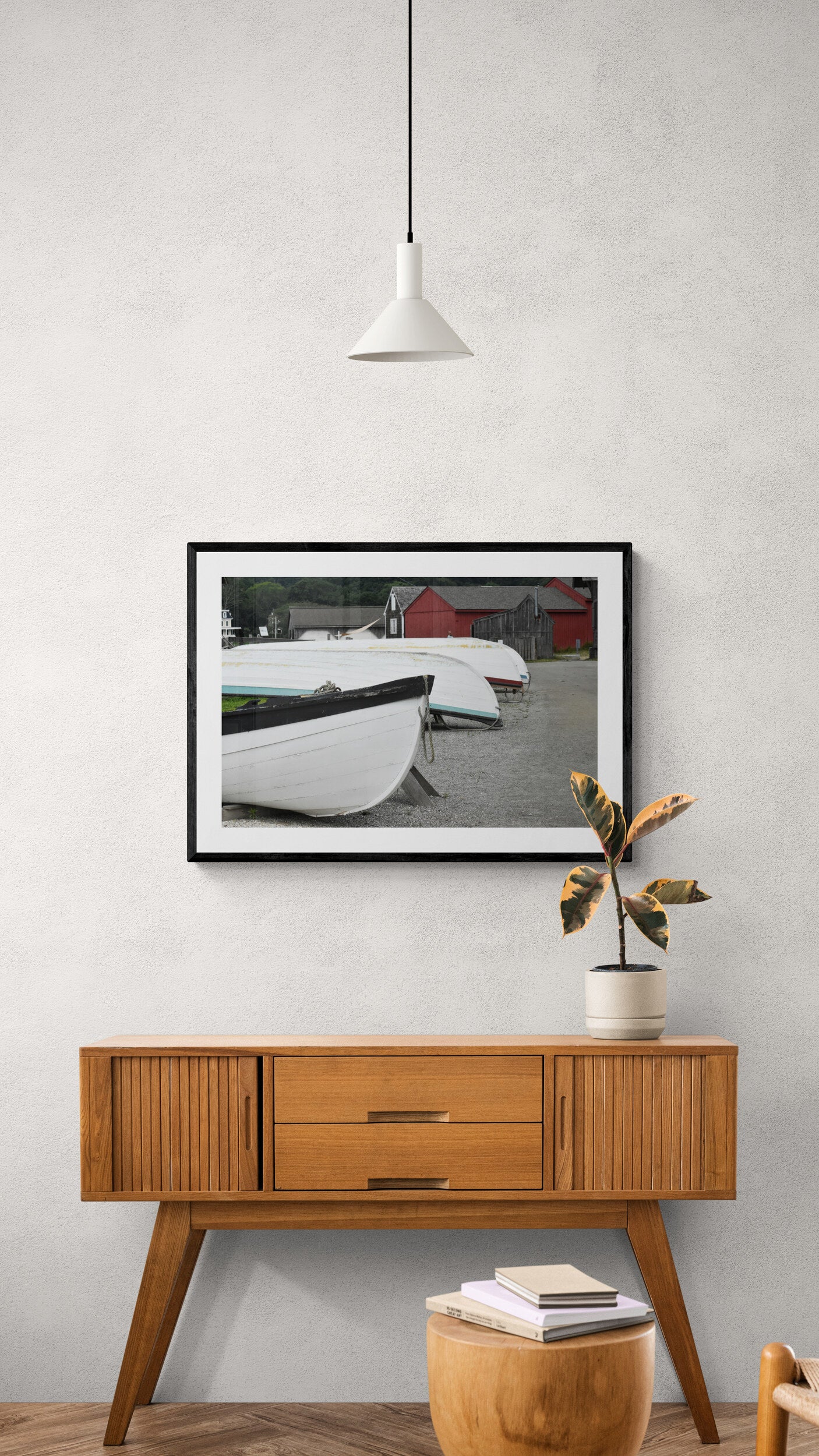 Framed photograph of boats on a wall above a wooden side table. Wooden Boats Original Photograph by Kim A. Bailey