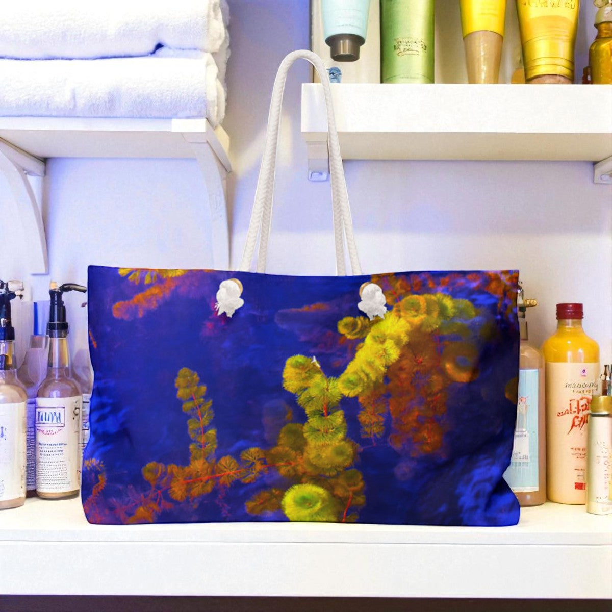 Colorful tote bag with coral design on a shelf with various bottles