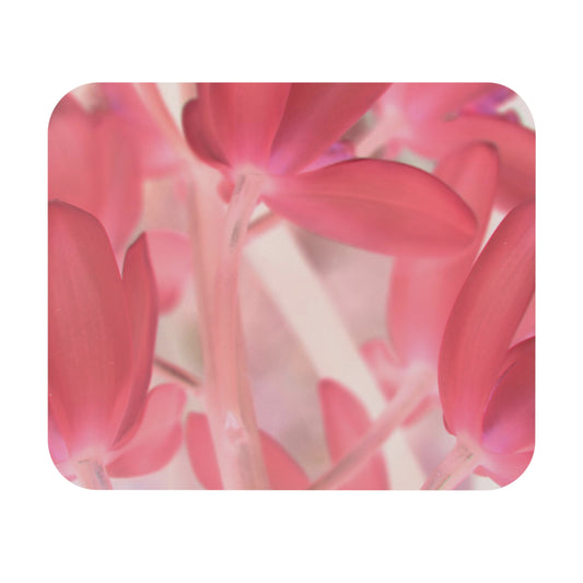 A close-up image of a mouse pad with a pink tinted orchid design.