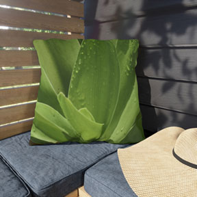 Green Leaves Square Outdoor Pillow on a Bench